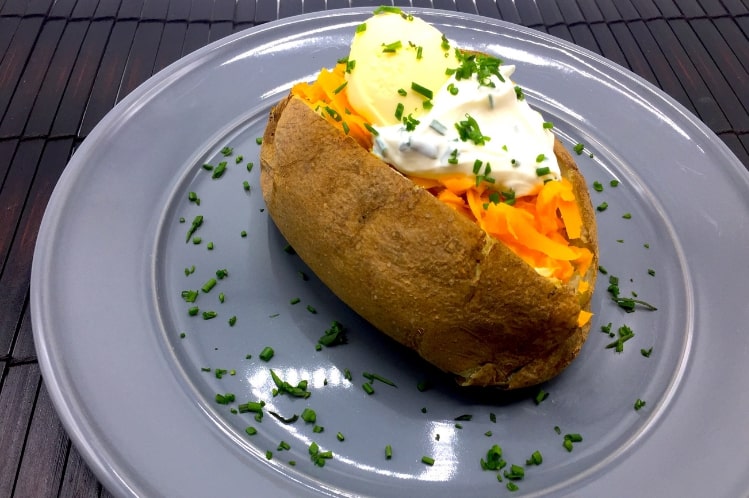 Loaded baked potato side dish with cheddar and chives from Meal Village