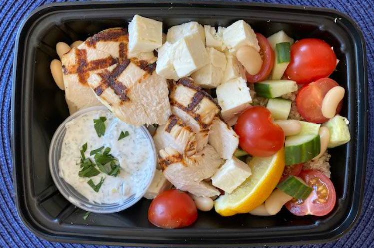 Mediterranean bowl with grilled lemon chicken, quinoa, white beans, cucumbers and tomatoes