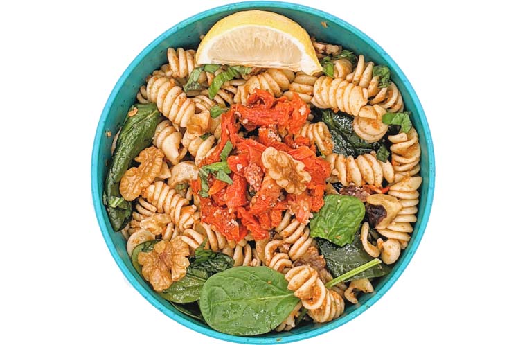 Bowtie pasta with sun dried tomato pesto, fresh spinach, chopped walnuts and basil