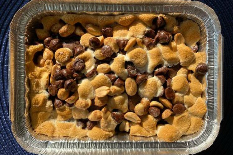 Rocky road brownies topped with toasted marshmallows, chocolate chips and salted peanuts.
