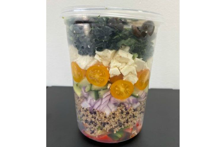 Quinoa salad with feta cheese, kale, cucumbers, peppers and Greek olives in a lemon basil vinaigrette.