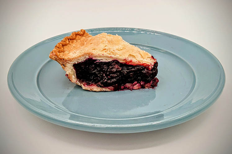 Blueberry pie with a flaky crust and sweet, juicy blueberry filling.