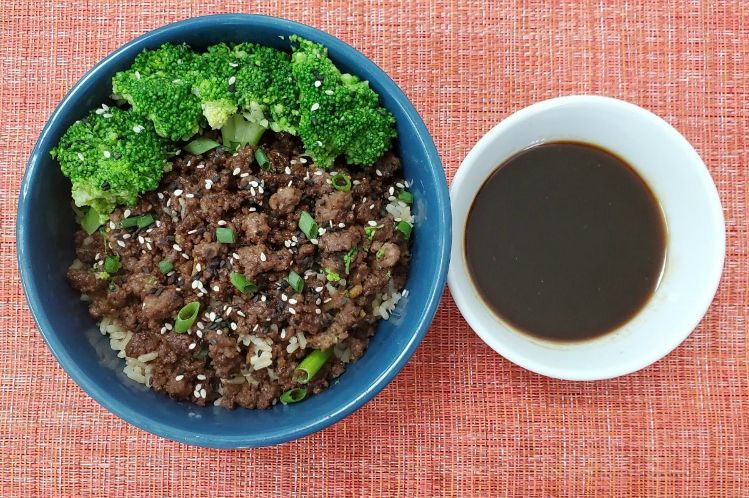 Korean flavored ground beef served over rice with broccoli in a bowl.